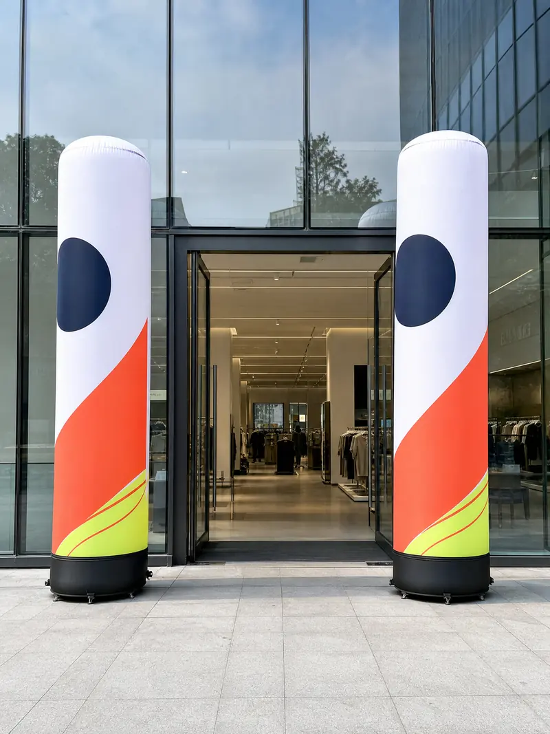 Two white inflatable columns at a store entrance