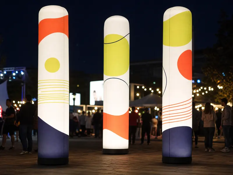 LED-lit inflatable columns at a night festival